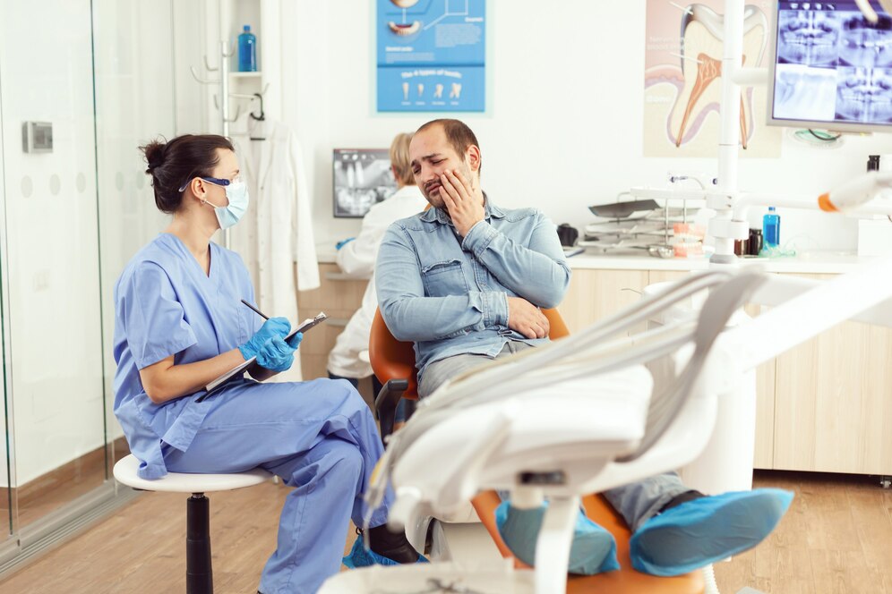 Patient receiving emergency dental treatment from a dentist in a clinic setting